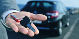 man offering a car key to the observer